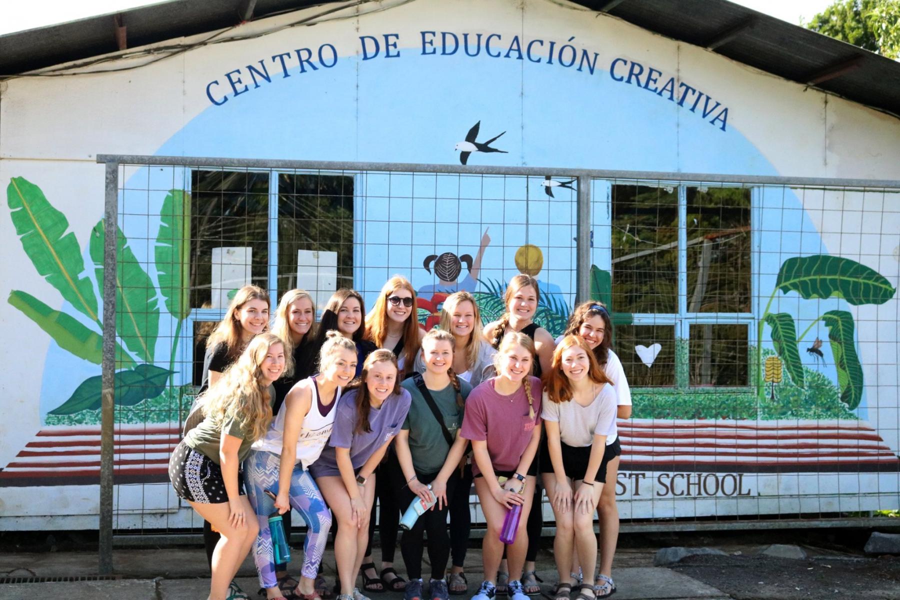 Students smiling outside of school in Costa Rica.